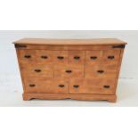 PINE EFFECT CHEST with a moulded top above an arrangement of eleven drawers, standing on bracket