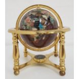 TABLE TOP TERRESTRIAL GLOBE with a brass frame and specimen stone globe, the base with an inset