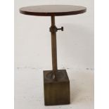 WALNUT OCCASIONAL TABLE with a segmented oval top raised on a square metal base and tubular