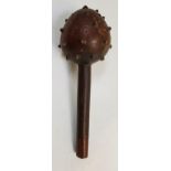 HARDWOOD MACE the bulbous head with brass studs, the handle with sinuous carved decoration, 36cm
