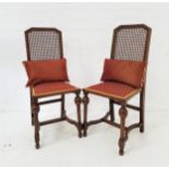 PAIR OF OAK SIDE CHAIRS with caned backs above padded seats, standing on turned front supports