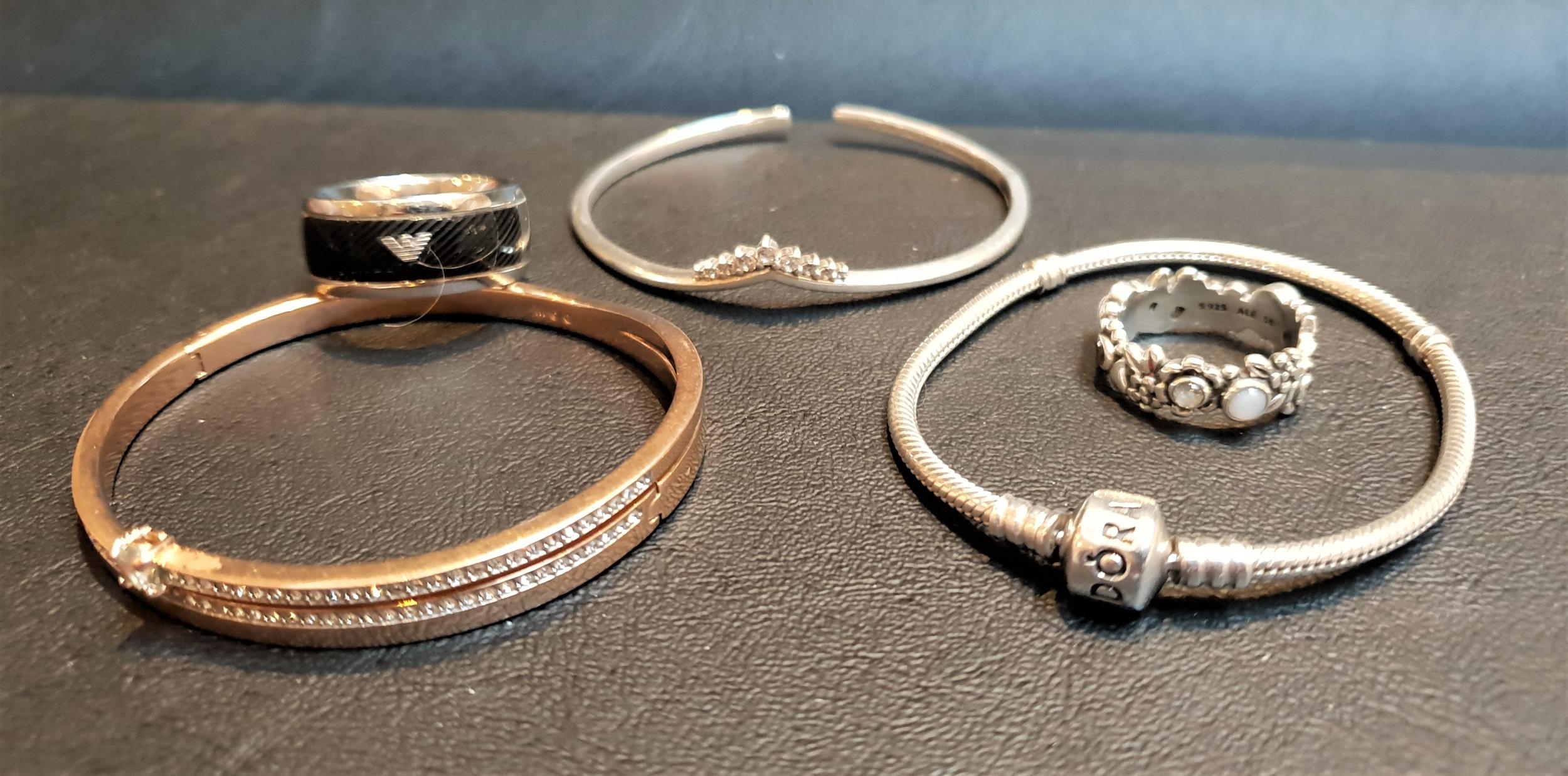 SELECTION OF FASHION JEWELLERY comprising a Pandora tiara bangle, a Pandora Moments silver charm