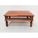 TEAK OCCASIONAL TABLE with a rectangular moulded top above a lattice work metal frieze, standing