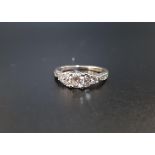 DIAMOND CLUSTER RING the central round brilliant cut diamond approximately 0.5cts, flanked by