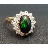 UNUSUAL BLACK OPAL AND DIAMOND CLUSTER RING the central oval cabochon opal in fourteen diamond