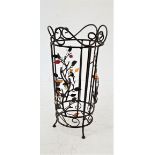 DECORATIVE STEEL STICK STAND with a shaped circular top above panels decorated with leaves and