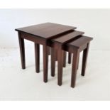 NEST OF TEAK OCCASIONAL TABLES all with square tops, standing on plain supports, 55.5cm high