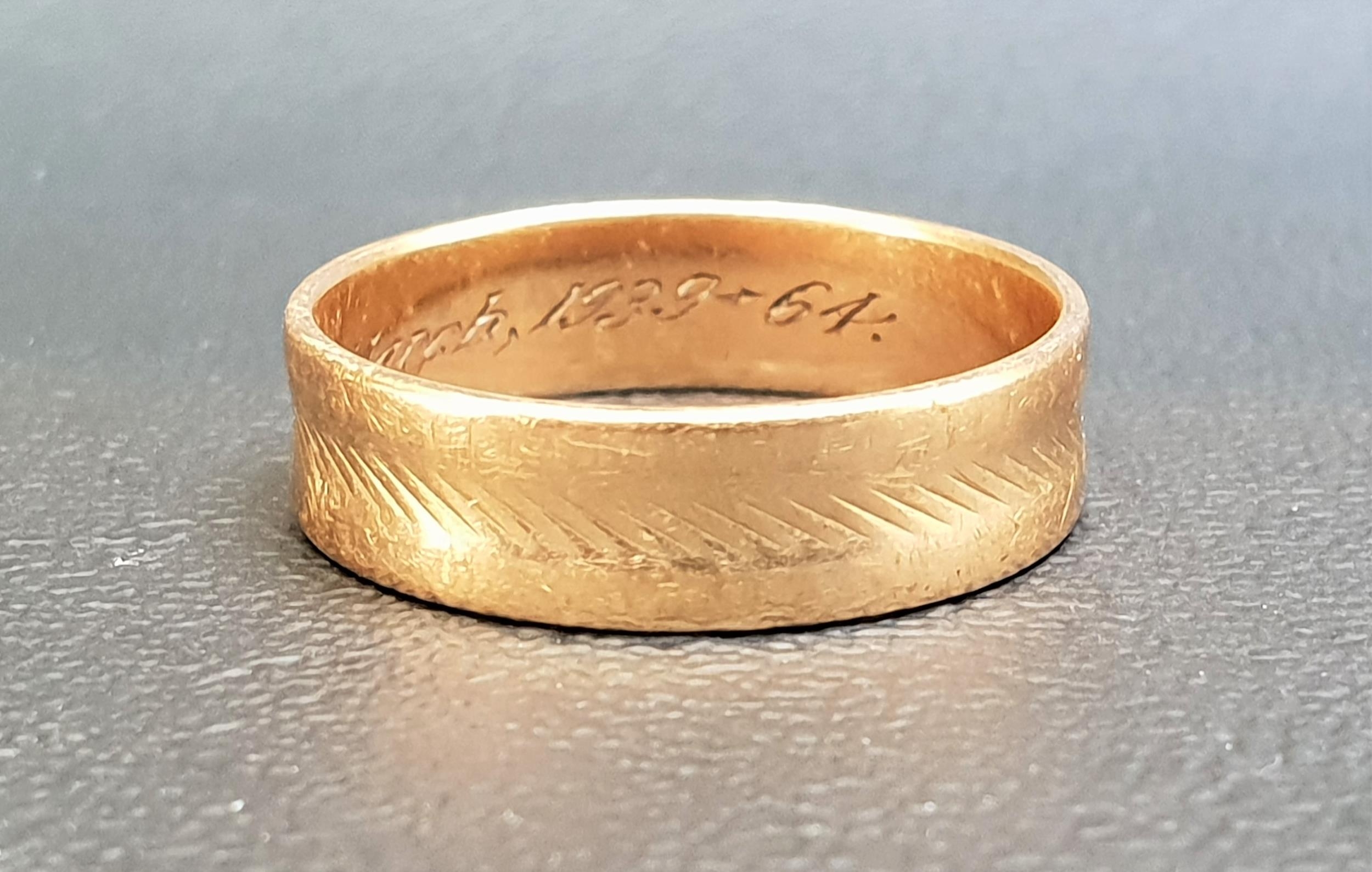 NINE CARAT GOLD WEDDING BAND with engraved decoration, ring size T-U and approximately 3.5 grams