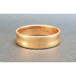 NINE CARAT GOLD WEDDING BAND with engraved decoration, ring size T-U and approximately 3.5 grams