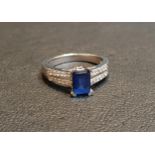 SAPPHIRE AND DIAMOND RING the emerald cut sapphire approximately 1.2cts flanked by diamonds to the