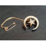 DIAMOND AND SEED PEARL BROOCH in the form of a crescent moon and central star, in unmarked gold