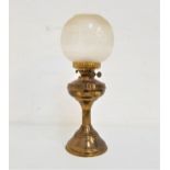 BRASS OIL LAMP raised on a circular base with a reeded column and shaped reservoir, with an etched