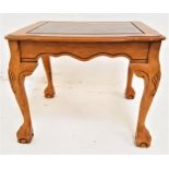 LIGHT OAK OCCASIONAL TABLE with an inset smoked glass top above a shaped frieze, standing on