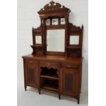 EDWARDIAN OAK MIRROR BACK SIDEBOARD with a shaped and carved pediment supported by a pair of