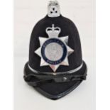 POLICE HELMET with the Cleveland Police force badge, with chin strap and named to PC Doherty