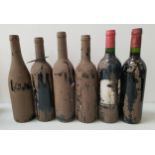 SIX BOTTLES OF UNKNOWN RED WINE all covered in a layer of dirt resulting in the labels being