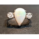 OPAL AND DIAMOND THREE STONE RING the central pear cabochon opal flanked by round cut diamonds