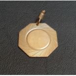 NINE CARAT GOLD OCTAGONAL MEDAL FOB with engraved detail, approximately 7.7 grams