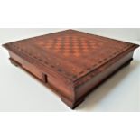 CONTINENTAL TEAK AND INLAID CHESS BOARD with white and black bone pieces, contained in two