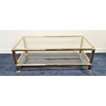 GILT METAL RECTANGULAR OCCASIONAL TABLE with an inset glass top above a glass undertier, 116cm long