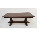 DARK OAK OCCASIONAL TABLE with an oblong moulded top, standing on a pair of bulbous supports with