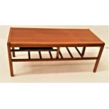 DANISH TEAK OCCASIONAL TABLE with a rectangular top above a slatted undertier, standing on shaped