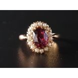 GARNET AND SEED PEARL CLUSTER RING the central oval cut garnet approximately two carats in seed