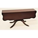 MAHOGANY OCCASIONAL TABLE with shaped drop flaps on a shaped sectional column with four outswept