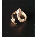 NINE CARAT GOLD SNAKE RING with textured finish to simulate scales and decorative coiled tail,