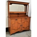 ARTS AND CRAFTS LIGHT OAK SIDEBOARD with a shaped bevelled mirror back above a shaped shelf, the