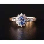 PRETTY SAPPHIRE AND DIAMOND CLUSTER RING the oval cut sapphire approximately 0.5cts in twelve