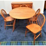 ERCOL BEECH AND ELM DINING ROOM SUITE comprising a sideboard with two frieze drawers above two