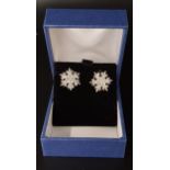 PAIR OF DIAMOND CLUSTER EARRINGS of snowflake design, in ten carat gold, approximately 1.2cm wide