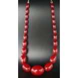 GRADUATED AMBER BEAD NECKLACE the largest bead approximately 3.2cm long, on silver gilt chain with