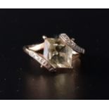 CITRINE AND DIAMOND RING the central princess cut citrine in diamond set twist setting overlapping