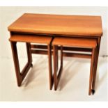 MCINTOSH TEAK OCCASIONAL TABLE with a fold over rotating top on shaped supports with casters, and