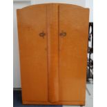 1950s BIRDS EYE MAPLE WARDROBE with arched shaped doors opening to reveal hanging space and a shelf,