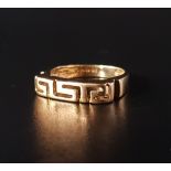 EIGHTEEN CARAT GOLD RING the pierced Greek key decoration, ring size N and approximately 4.1 grams