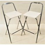 PAIR OF HIGH KITCHEN STOOLS of tubular steel construction with white plastic seats (2)