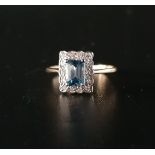 BLUE TOPAZ AND DIAMOND CLUSTER RING the emerald cut topaz approximately 0.7cts, in fourteen