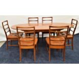 MCINTOSH TEAK EXTENDING DINING TABLE with an oval pull apart top and fold out leaf, standing on