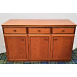 TEAK SIDEBOARD with one short and one long frieze drawer, above three panelled cupboard doors,