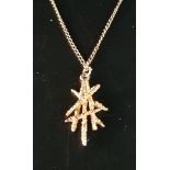 NINE CARAT GOLD PENDANT of abstract design with textured finish, on nine carat gold chain, total