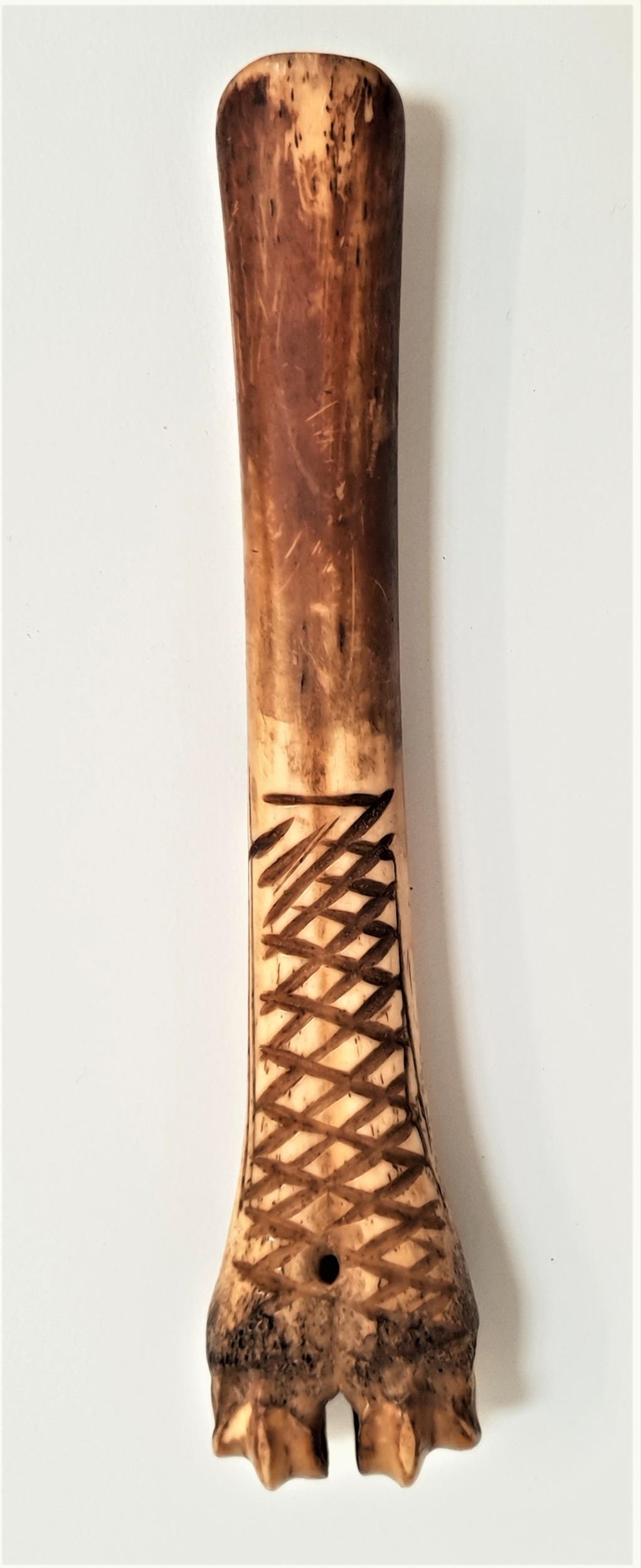 19th CENTURY CARVED BONE CHEESE SCOOP with lattice style carved decoration, 14cm long