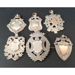 SIX VICTORIAN AND LATER SILVER MEDAL FOBS including two with gold detail, one with brooch