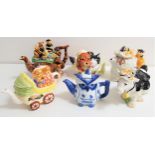 SIX NOVELTY TEAPOTS comprising cat and dog, the wise owl, teddy bear's picnic, a cow, teddy bears in
