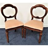 PAIR OF VICTORIAN BALLOON BACK DINING CHAIRS with shaped stuffover drop in seats, standing on turned