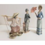 THREE LARGE LLADRO PORCELAIN FIGURINES depicting Charlie Chaplin, 28.5cm high, lady with a