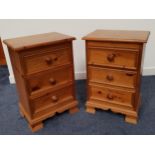 PAIR OF WAXED PINE BEDSIDE CHESTS with a moulded top above three panelled drawers, standing on