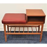 1950s TEAK AND BEECH TELEPHONE TABLE with a red vinyl covered seat next to a teak shelf with a